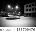 Snowy urban night scene with falling snow and streetlights 133709476