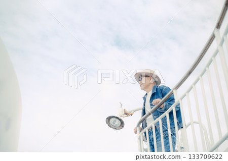 Portrait of a senior man standing on the deck of a ferry 133709622