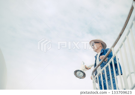 Portrait of a senior man standing on the deck of a ferry Portrait of a senior man standing on the deck of a ferry 133709623