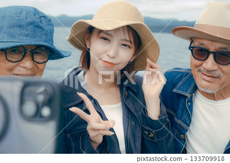 Portrait of three people taking a selfie on a ferry Portrait of three people taking a selfie on a ferry 133709918