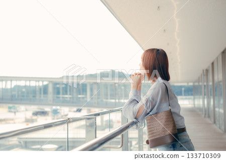 一位女子側臉望著碼頭的鏡頭。 133710309