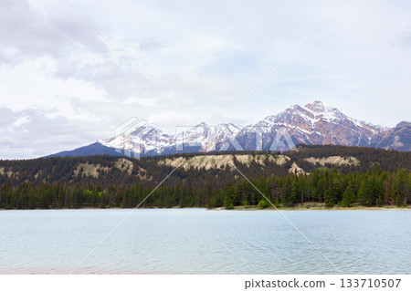 Scenic view to cyan cold waters of the mountain lake. Scenic view to cyan cold waters of the mountain lake. 133710507