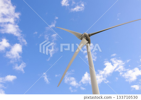 Windmill with huge blades in the sky, sustainable energy source Windmill with huge blades in the sky, sustainable energy source 133710530