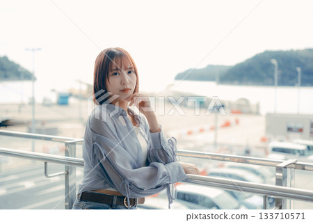 Portrait of a young woman smiling outdoors Portrait of a young woman smiling outdoors 133710571