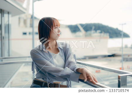Portrait of a young woman smiling outdoors Portrait of a young woman smiling outdoors 133710574