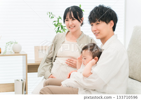 Pregnant mother showing her baby to her child, family, parent and child 133710596