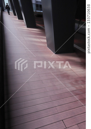 Walking along the pedestrian deck in front of Hakata Station 133710638