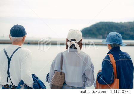 Portrait of three people standing side by side at the harbor Portrait of three people standing side by side at the harbor 133710781