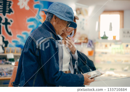 A parent and child checking out products in the store A parent and child checking out products in the store 133710884