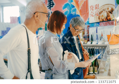 Three people talking while looking at products in the store 133711075