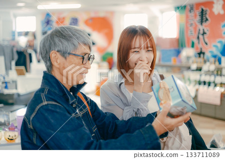 A parent and child checking out products in the store A parent and child checking out products in the store 133711089