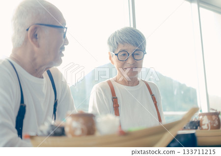 Smiles spread over the lunchtime meal in front of the boat-shaped platter 133711215