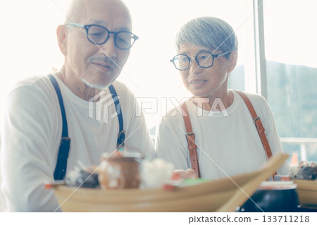 Smiles spread over the lunchtime meal in front of the boat-shaped platter Smiles spread over the lunchtime meal in front of the boat-shaped platter 133711218
