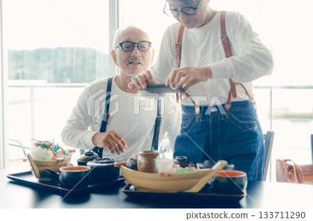 A moment before the meal, taking a photo of the boat-shaped platter with a smartphone A moment before the meal, taking a photo of the boat-shaped platter with a smartphone 133711290