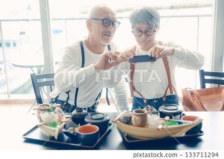 A moment before the meal, taking a photo of the boat-shaped platter with a smartphone A moment before the meal, taking a photo of the boat-shaped platter with a smartphone 133711294