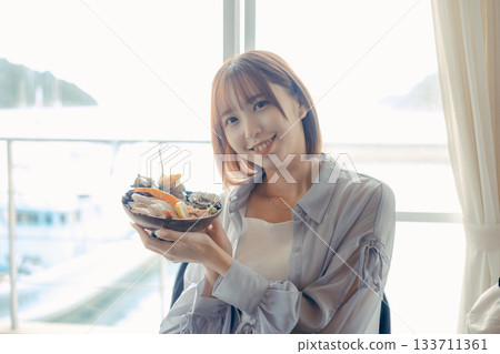 A moment from traveling with a seafood bowl in hand 133711361