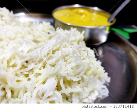 Traditional Indian Kadhi with Steamed Rice Served in Steel Plate Traditional Indian Kadhi with Steamed Rice Served in Steel Plate 133711418