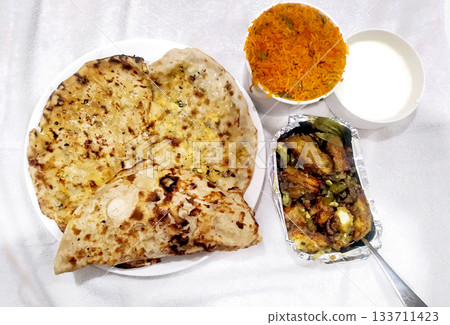 North Indian Meal with Paratha, Rice, Curry and Curd North Indian Meal with Paratha, Rice, Curry and Curd 133711423