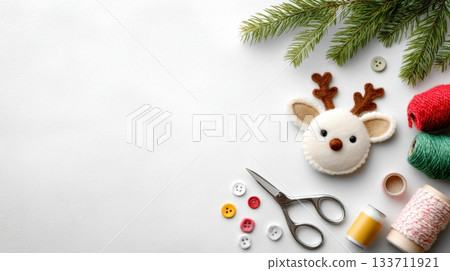 Crafting a festive reindeer ornament with colorful threads, scissors, and buttons on a clean white surface with holiday spirit 133711921