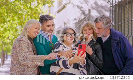 Happy senior friends taking a selfie together outdoors Happy senior friends taking a selfie together outdoors 133712205