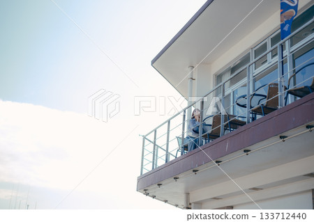 Portrait of a woman in her twenties smiling at the seaside 133712440