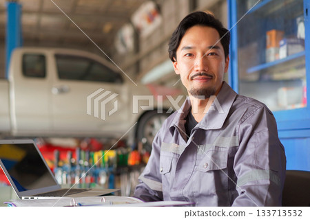 Repairman portrait in garage. Repairman portrait in garage. 133713532