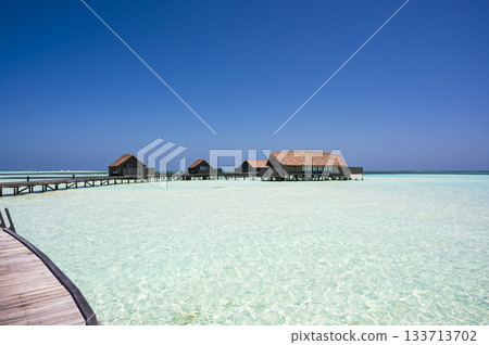 Water cottages floating on the sandy beach Water cottages floating on the sandy beach 133713702