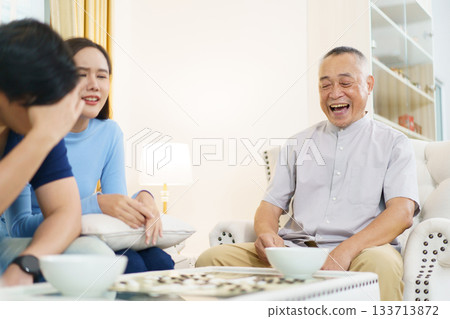 Encouraging the elderly to play brain-stimulating games like this helps prevent memory-related illnesses such as dementia. 133713872