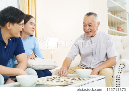 Encouraging the elderly to play brain-stimulating games like this helps prevent memory-related illnesses such as dementia. 133713873