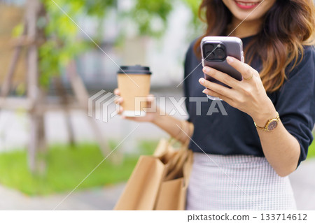 Asian businesswoman walking on the street in city. 133714612