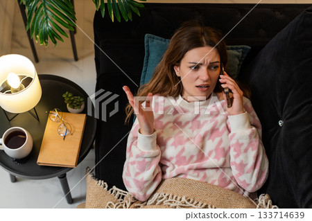 Adult woman annoyed by late spam phone call answers argues ends call blocks number returns to sleep Adult woman annoyed by late spam phone call answers argues ends call blocks number returns to sleep 133714639