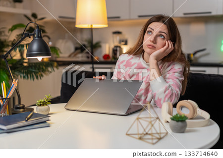 Adult woman irritated by workload waves hand closes laptop ends late shift plans new start tomorrow Adult woman irritated by workload waves hand closes laptop ends late shift plans new start tomorrow 133714640