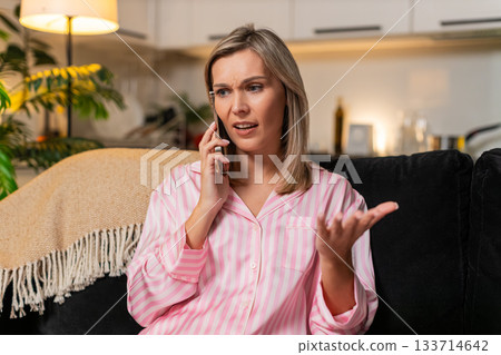 Adult woman angry smartphone call argues frowns sharp gesture rejects offer blocks spam scam caller Adult woman angry smartphone call argues frowns sharp gesture rejects offer blocks spam scam caller 133714642