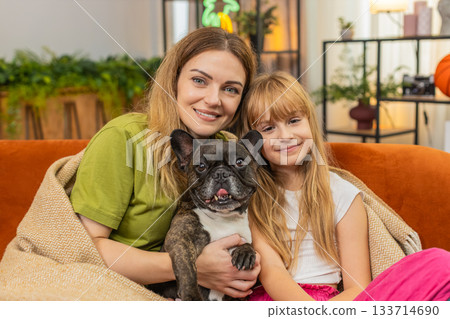 Mother daughter dog close family portrait smiling look to camera friendly pose together happy photo Mother daughter dog close family portrait smiling look to camera friendly pose together happy photo 133714690