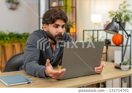 Indian man faces laptop app crash virus glitch error does facepalm annoyed frustrated reaction upset 133714701