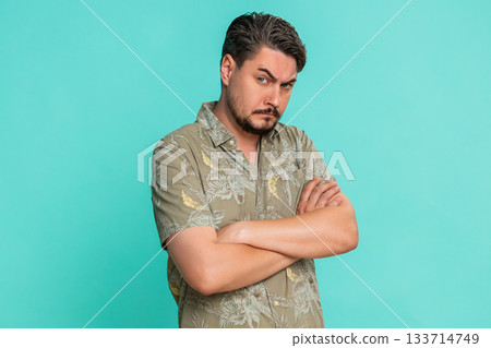 Adult man showing suspicion mistrust with squinted eyes tilted head expressing doubt and uncertainty Adult man showing suspicion mistrust with squinted eyes tilted head expressing doubt and uncertainty 133714749