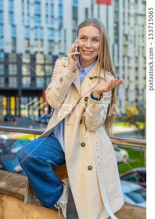 Mature Caucasian businesswoman having remote conversation on smartphone on downtown city street Mature Caucasian businesswoman having remote conversation on smartphone on downtown city street 133715065