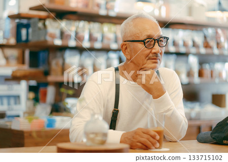 Senior man relaxing at a cafe Senior man relaxing at a cafe 133715102