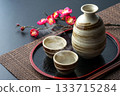 Japanese style image of steaming sake and plum branches 133715284