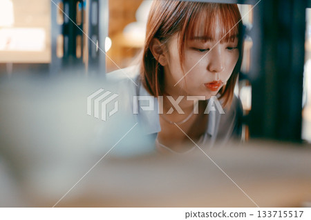 A local stroll scene featuring a woman in her twenties picking up cafe goods A local stroll scene featuring a woman in her twenties picking up cafe goods 133715517