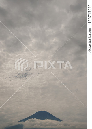 The fantastical scenery of Mount Fuji and Oshino Village, bathed in light filtering through the high clouds The fantastical scenery of Mount Fuji and Oshino Village, bathed in light filtering through the high clouds 133715965