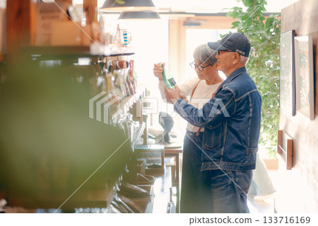 Everyday scene of a senior couple choosing products in a store 133716169