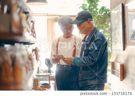 Everyday scene of a senior couple choosing products in a store 133716178