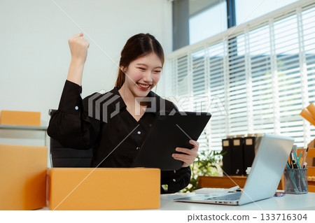 Successful Woman start up online seller at workplace. small business entrepreneur SME or freelance asian woman working with box at home. Successful Woman start up online seller at workplace. small business entrepreneur SME or freelance asian woman working with box at home. 133716304