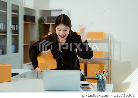 Successful Woman start up online seller at workplace. small business entrepreneur SME or freelance asian woman working with box at home. Successful Woman start up online seller at workplace. small business entrepreneur SME or freelance asian woman working with box at home. 133716308