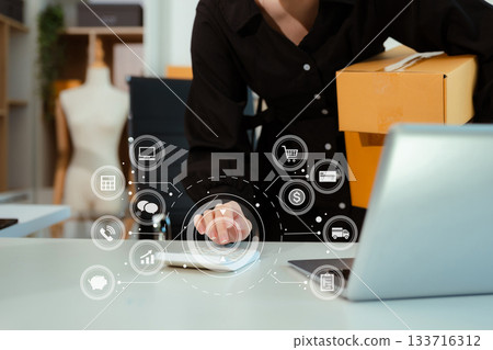 Entrepreneur women working at home about online business. Business owner woman using calculator and laptop working at home office. 133716312