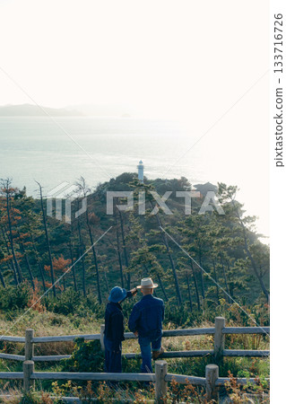 Senior couple looking at the view from the observation deck Senior couple looking at the view from the observation deck 133716726