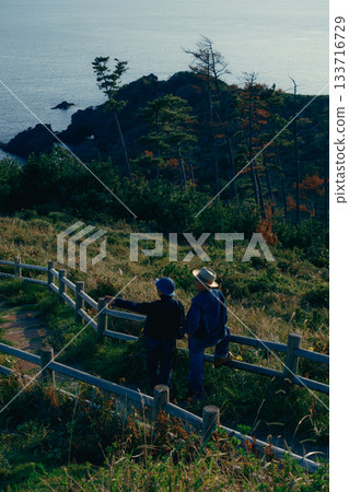 Senior couple looking at the view from the observation deck Senior couple looking at the view from the observation deck 133716729