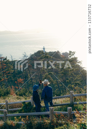 Senior couple looking at the view from the observation deck Senior couple looking at the view from the observation deck 133716732
