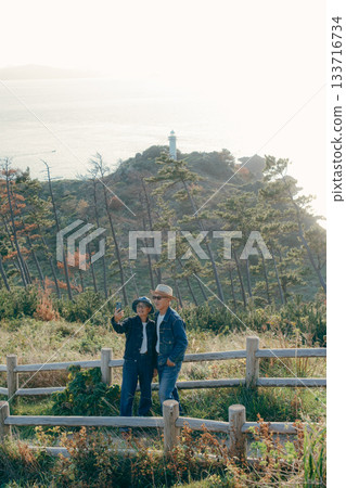 Senior couple looking at the view from the observation deck Senior couple looking at the view from the observation deck 133716734